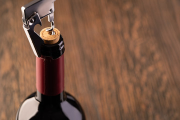 Corkscrew and bottle of wine