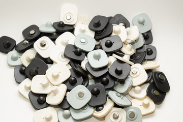 many multi-colored anti-theft sensor on a light background