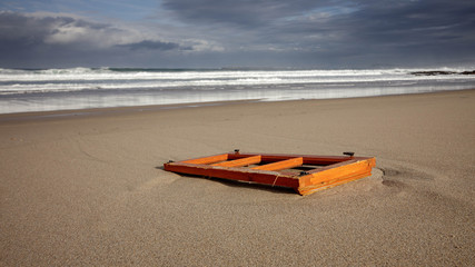Remains of beach front shack washed up on a beach in Barranan Galicia Spain