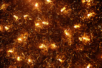 Fototapeta na wymiar Part of Christmas decorative yellow and white flashing lights, close up. Detail of New Year and Christmas decorations, string rice lights bulbs. Ornaments to christmas celebration, holiday scene.