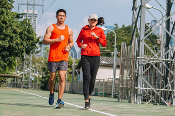 young couple runner running on running road in city park;sport, people, exercising and lifestyle concept