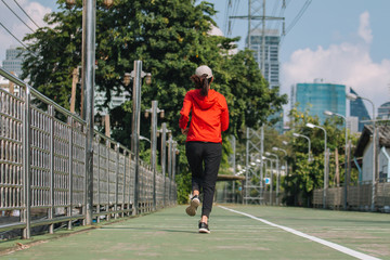Young women runner on the street be running for exercise on city road; sport, people, exercising and lifestyle concept
