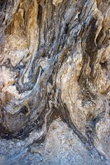 Dry salt at the surface of a rocky cliff at a beach by the sea at summer in Greece. Abstract textured background