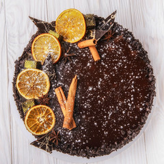 chocolate cake with orange on a wooden table