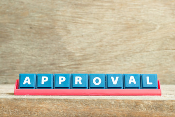 Fototapeta premium Tile letter on red rack in word approval on wood background
