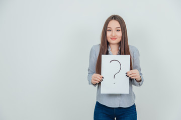 Inquisitive asian student girl holding a sheet of paper with question mark written on it.