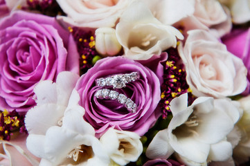 Wedding rings display in bouquet of flowers