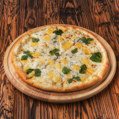 pizza with cheese on a wooden table