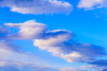 Dramatic puffy clouds isolated against blue skies