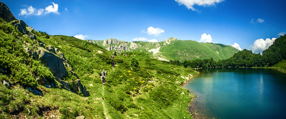 Naklejka na ściany i meble Panoramic view of beautiful mountain range with crystal clear lake