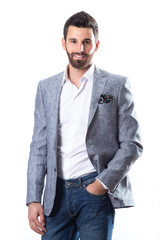 A young man wearing a Blazer in blue jeans on a white background