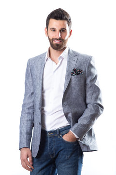 A Young Man Wearing A Blazer In Blue Jeans On A White Background