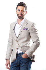 A young man wearing a Blazer in blue jeans on a white background