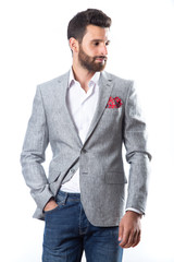 A young man wearing a Blazer in blue jeans on a white background