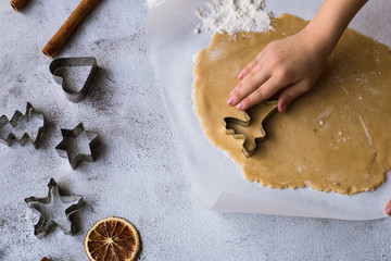 Cooking Christmas gingerbread cookies on a gray background