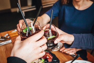Young ladys enjoying time together in cafe, friends drinking cold drinks and eat breakfasts together.