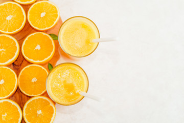 orange juice in a glass, top view, slices of oranges, straw, healthy lifestyle concept