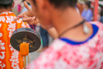 people hit small gong with stick orange cloth in wedding parade thailand