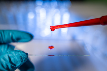 drop of blood on a glass slide using micropipette microtip