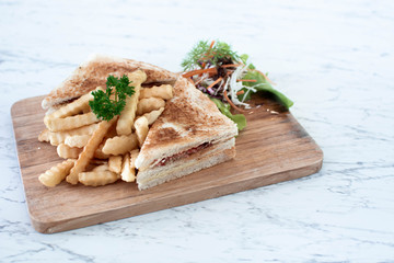 Ham Cheese sandwiches with french fries on wooden tray