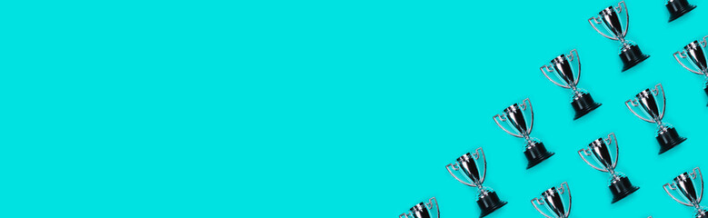 Banner with Pattern made with champion cup and copy space on blue background, Flat lay style. Open...