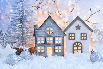 Christmas composition with decorative huts and festive decorations оn the snow. Christmas or New...