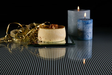 Delicious pudding decorated with ribbons on a glass plate