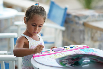 4-year-old girl colors with interest