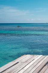 Fototapeta premium Wooden pier by the beach in tropical country.