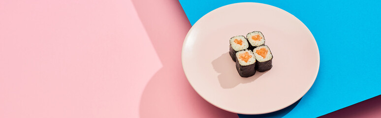 fresh maki with salmon on blue, pink background, panoramic shot © LIGHTFIELD STUDIOS