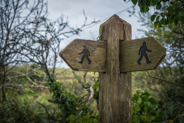 double sign post with walking symbols 