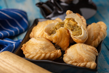 Homemade chicken Curry puffs on wooden table
