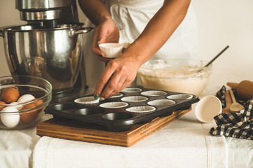 Confectioner girl is preparing a cupcake. Concept ingredients for cooking flour products or dessert