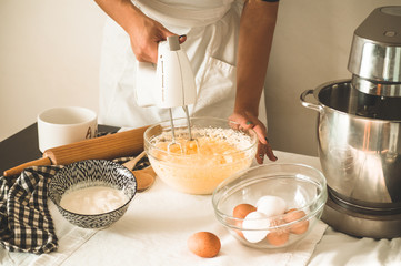 Confectioner girl is preparing a cake. Concept ingredients for cooking flour products or dessert