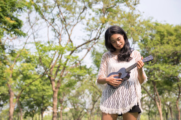 woman play Ukulele in garden