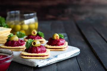 Beetroot relish on crackers. An original party snack.