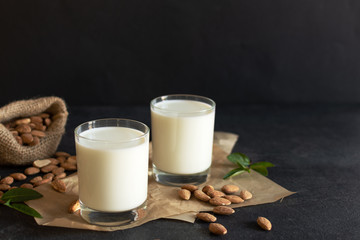 Organic Almond milk in glass with almond nuts. Healthy eating concept.