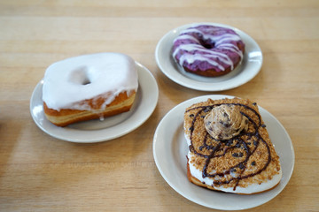 Vanilla glazed donut served with chocolate chips cookie and blueberry cake doughnut