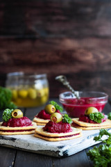 Beetroot relish on crackers. An original party snack.