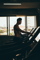 Fototapeta na wymiar strong man exercising in the sport gym