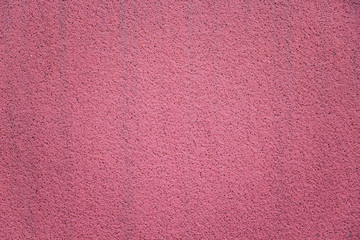 Bright pink stucco wall closeup