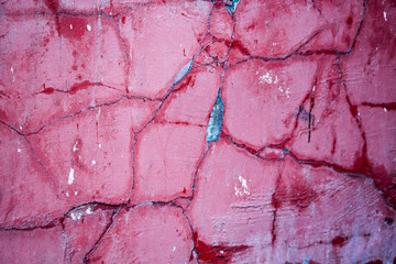 Naklejka premium Cracks on a pink wall closeup