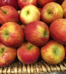 many red apples in basket on the counter