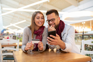 A couple is browsing through some romantic traveling destinations and travel offers. They are planning a perfect vacation.