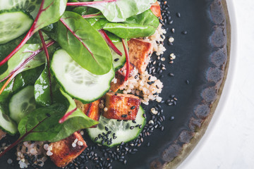 Vegan tofu poke bowl with baby chard and quinoa