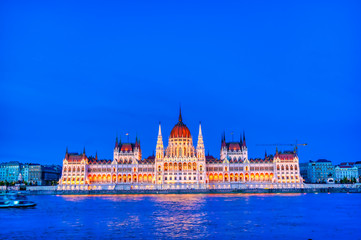 Fototapeta premium The Hungarian Parliament Building located on the Danube River in Budapest Hungary at sunset.