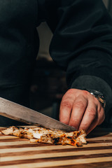 cutting grilled chicken