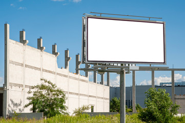 Fototapeta premium Blank white billboard for advertisement in the front of construction site on a sunny summer day.
