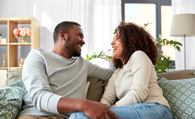 relationships and people concept - happy african american couple at home