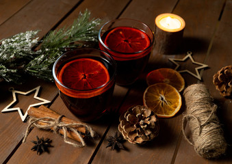 Christmas drinks of mulled wine and orange on a wooden table